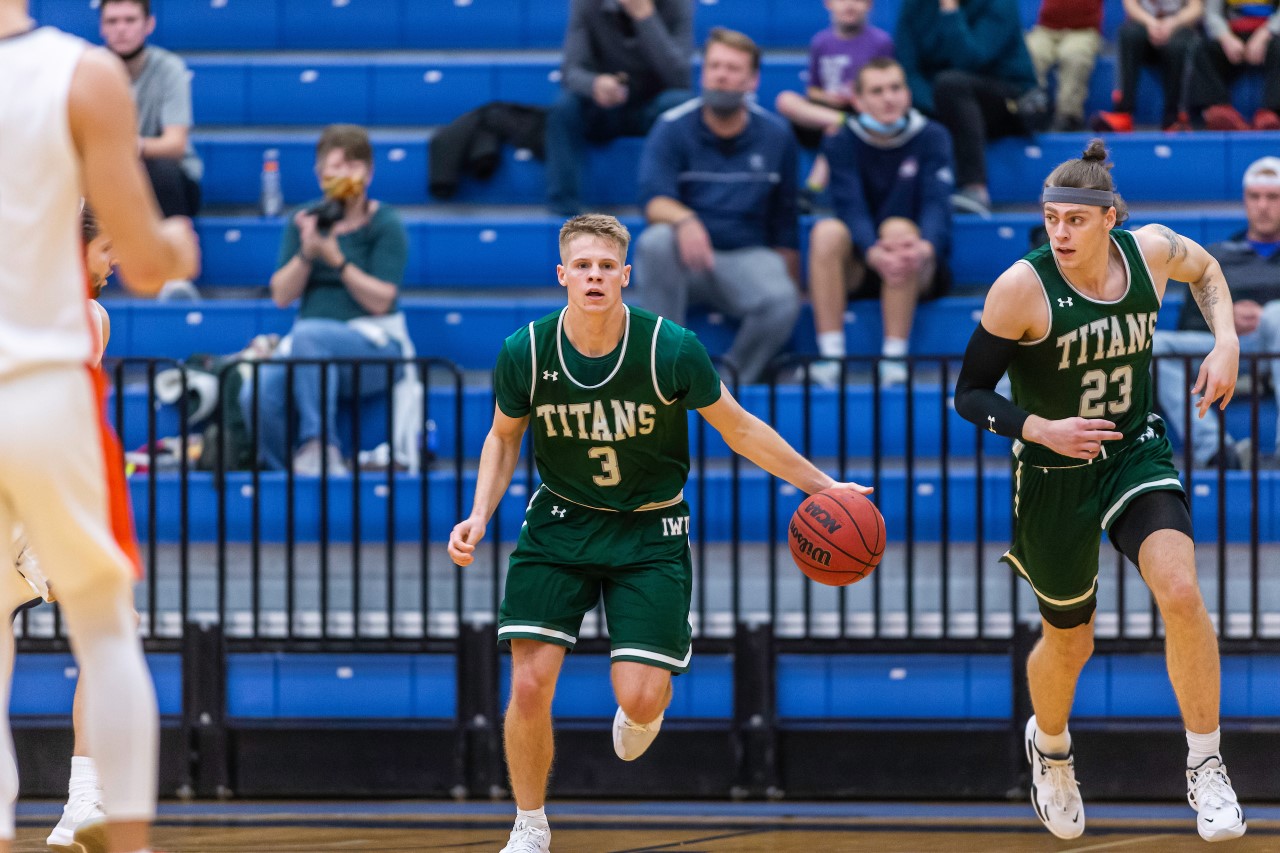 Titans guard Cory Noe takes the ball up the court